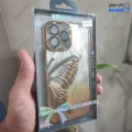 قاب گوشی آیفون 15 پرو مکس (کاور Unique محافظ لنز دار طرح بال پروانه آکواریومی رنگ طلایی)