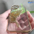 قاب گوشی آیفون 15 (کاور Unique محافظ لنز دار طرح بال پروانه آکواریومی رنگ طلایی)